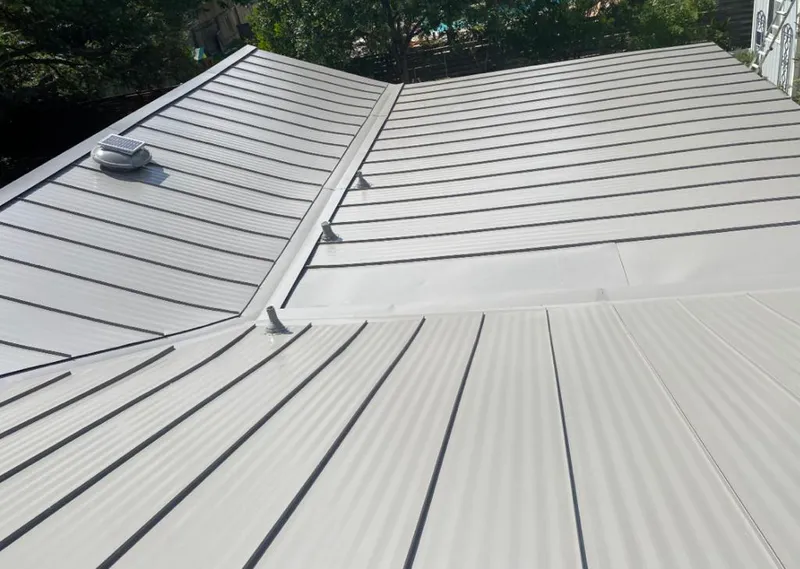 Solar attic fan installed on a metal roof for Roof Ventilation in Irondequoit